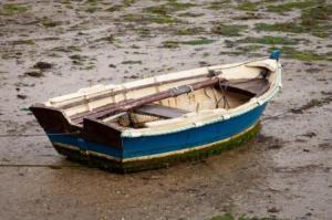 little-fishing-boat-stranded-wet-sand-low-tide-90786222